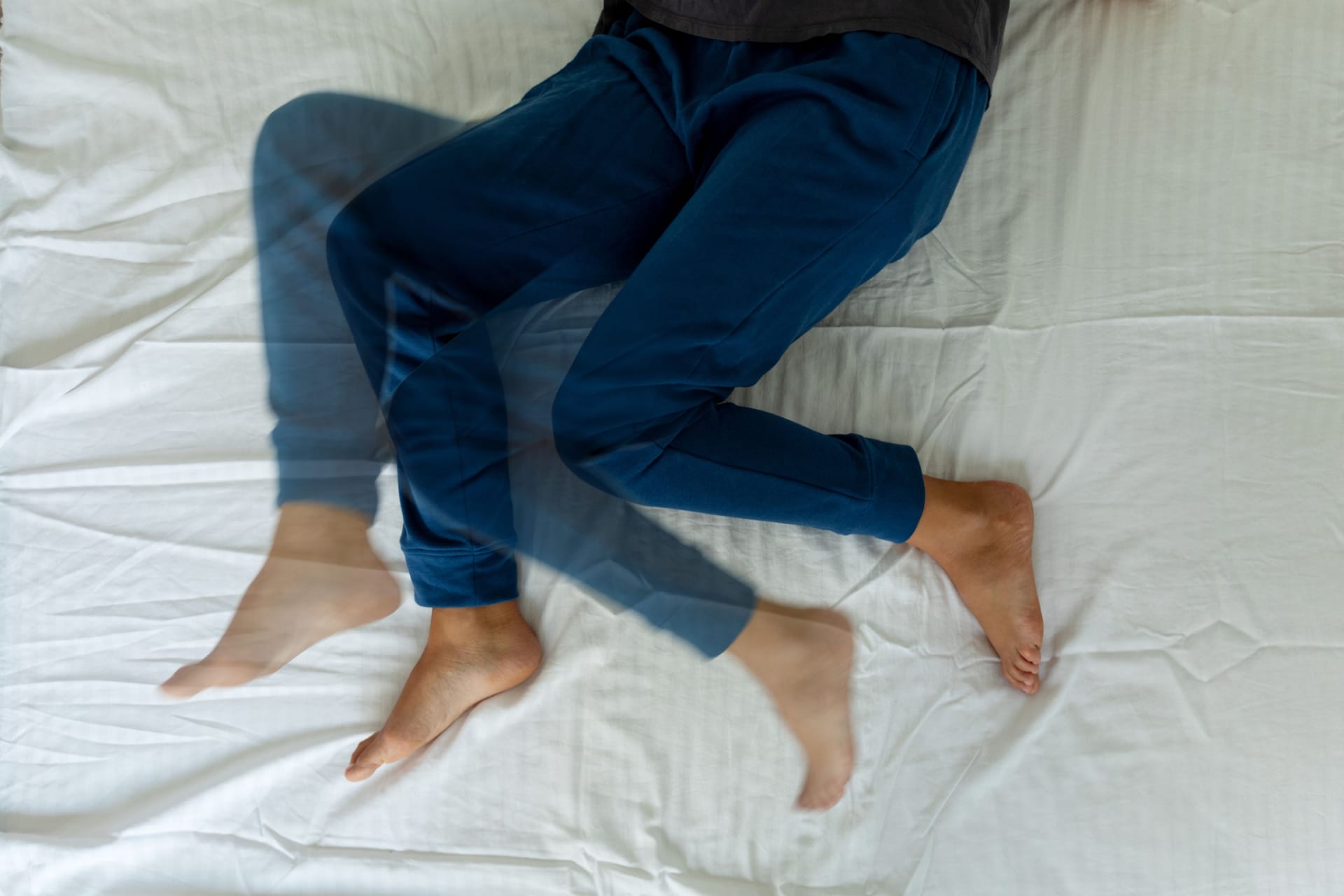 Frau im Bett: Unruhige Beine treten häufig abends beim Einschlafen oder auch in der Nacht auf. Frau im Bett: Unruhige Beine treten häufig abends beim Einschlafen oder auch in der Nacht auf.